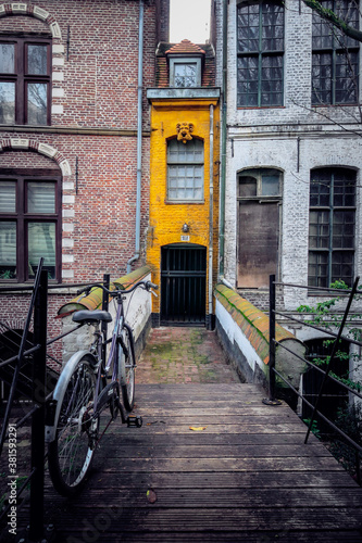 A very narrow little house, in yellow brick, between two buildings, in the center of Lille, France