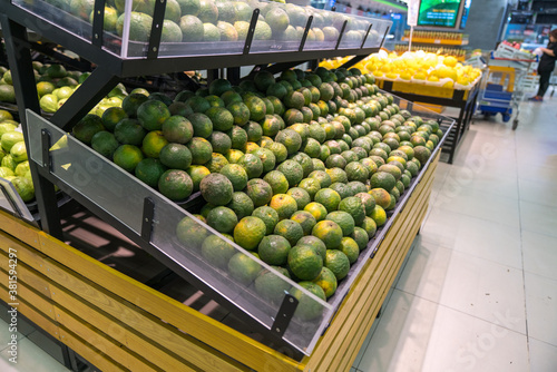 Fresh healthy fruits on shelves in supermarket