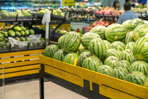 Fresh healthy fruits on shelves in supermarket
