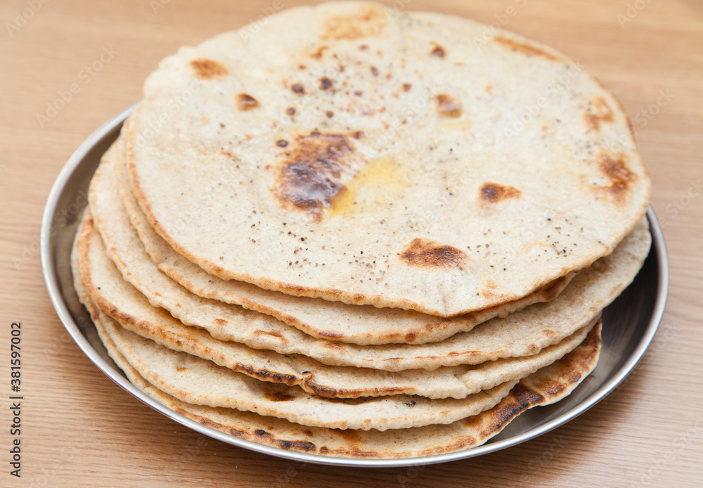 Stack of fresh wholewheat flatbread with butter Stack of fresh wholewheat flatbread with butter