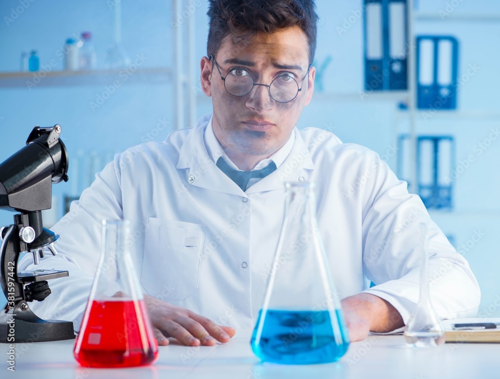 Fototapeta premium Funny mad chemist working in a laboratory