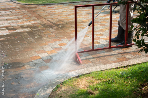 Outdoor floor cleaning with a pressure water jet on street © Hanoi Photography