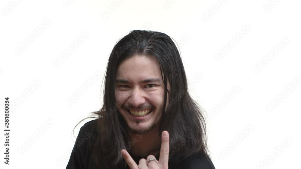 Close-up of excited east-asian rocker with long dark hair and piercing, showing heavy metal sign with sassy pleased smile, likes music, standing over white background Close-up of excited east-asian rocker with long dark hair and piercing, showing heavy metal sign with sassy pleased smile, likes music, standing over white background