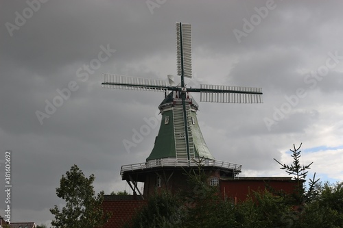 Old windmill in the region Altes Land, on the shore of the Elbe river. North Germany, Europe.