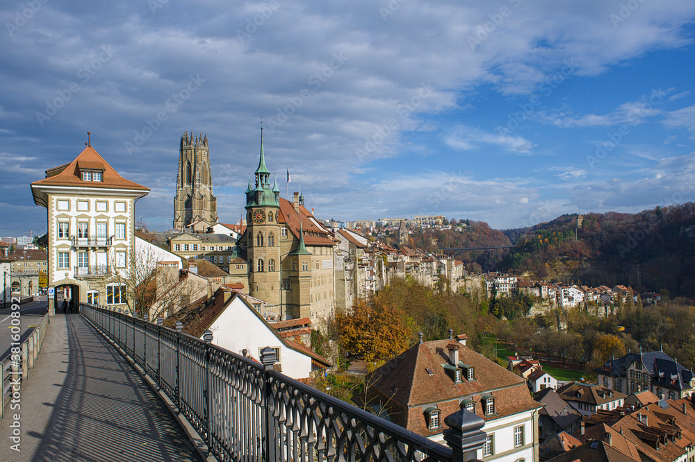 view of the Lower Town with in the background, the St. Nicholas Cathedral and the Gottéron Bridge in Fribourg, Switzerland