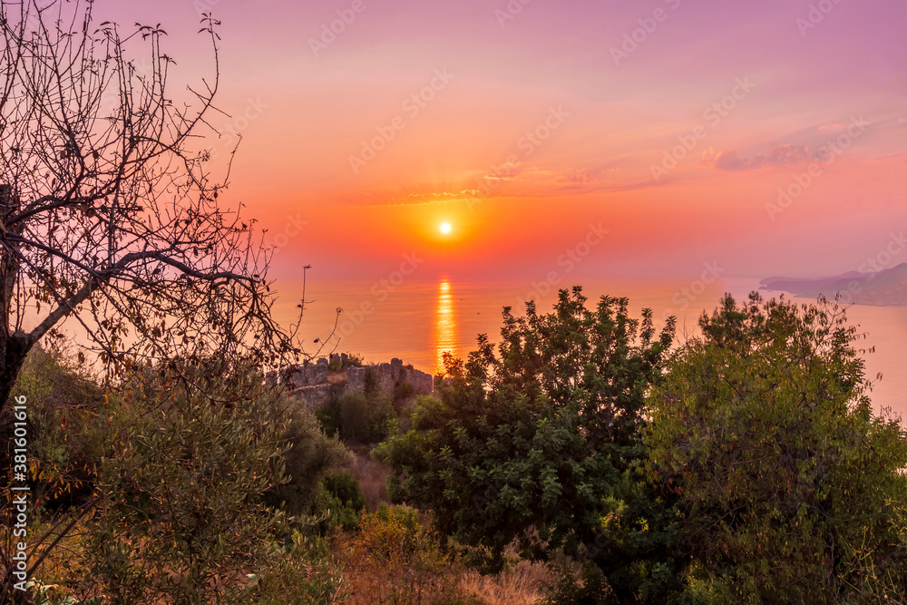 scenic view at picturesque sunset from high mountain with bushes and green trees below and beautiful cloudy sky, sea with far coast, sun glow with reflection on the background , castle landscape scenic view at picturesque sunset from high mountain with bushes and green trees below and beautiful cloudy sky, sea with far coast, sun glow with reflection on the background , castle landscape