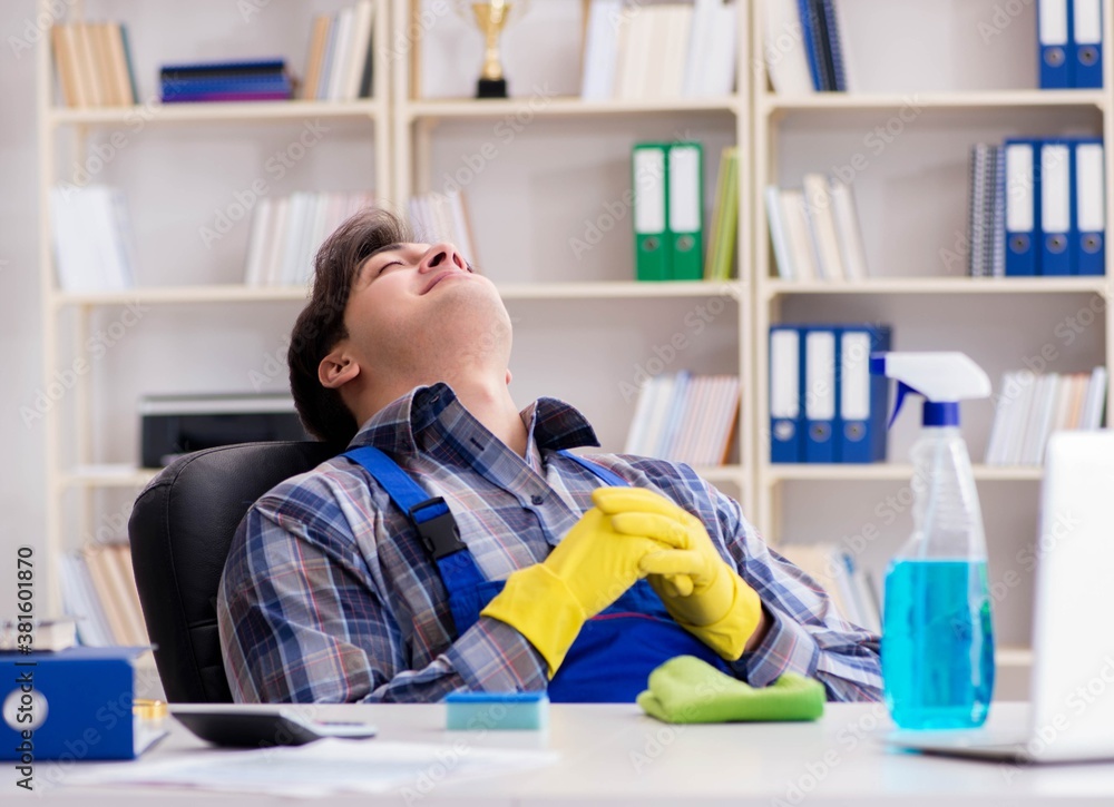 Male cleaner working in the office Male cleaner working in the office