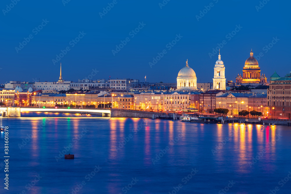 Night view of illuminated Tuchkov Bridge with church and Saint Isaac's Cathedral, Saint-Petersburg, Russia