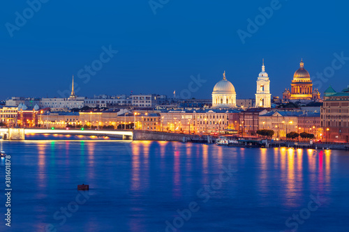 Night view of illuminated Tuchkov Bridge with church and Saint Isaac's Cathedral, Saint-Petersburg, Russia