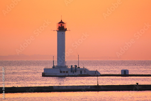 lighthouse at sunset in port