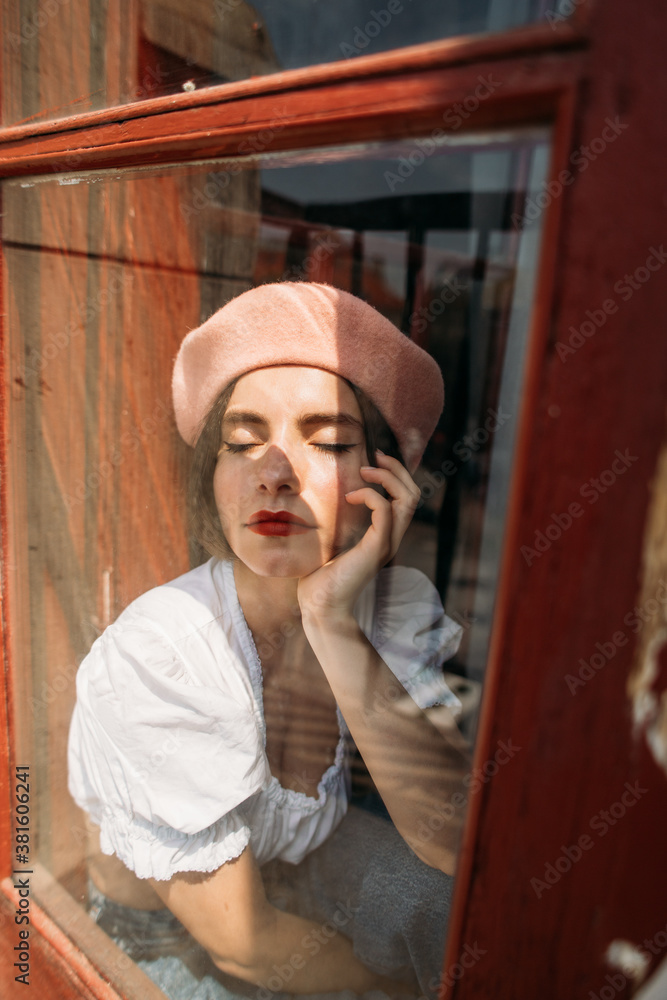 young stylish woman in a beret in an atmospheric interior