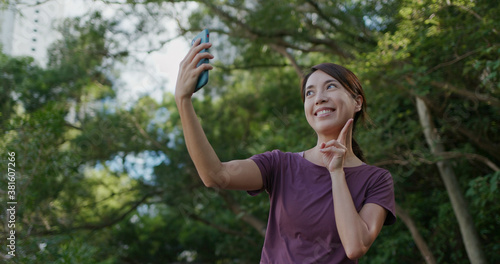 Woman take selfie on cellphone at park
