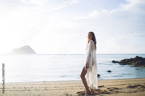 Young woman in beachwear standing on peaceful shore