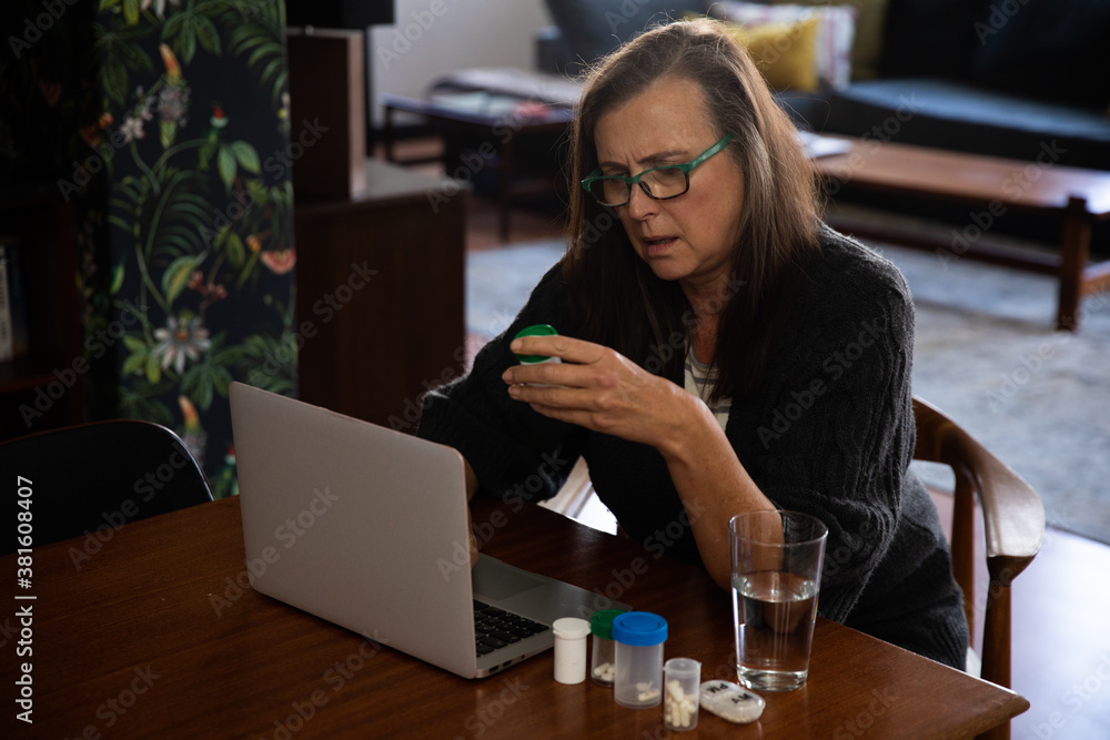 Senior woman holding an empty medication container