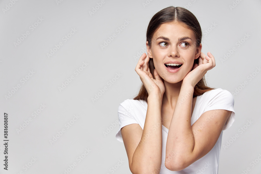 Woman straightens her hair look to the side smile Woman straightens her hair look to the side smile