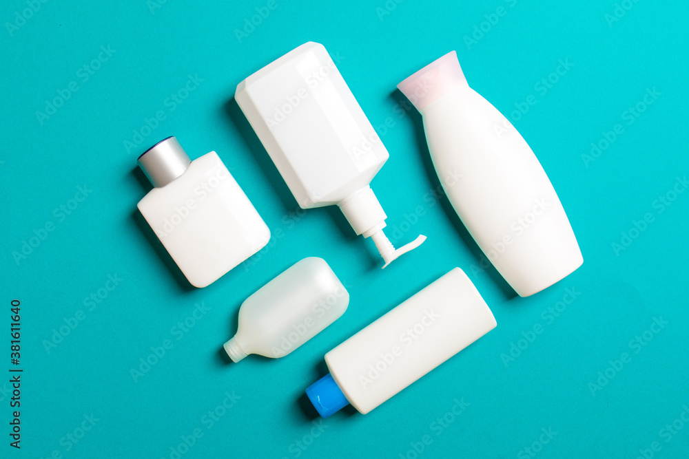 Set of White Cosmetic containers isolated on colored background, top view with copy space. Group of plastic bodycare bottle containers with empty space for you design Set of White Cosmetic containers isolated on colored background, top view with copy space. Group of plastic bodycare bottle containers with empty space for you design