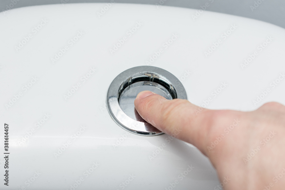 Hand flush toilet, hand close up, cropped image Hand flush toilet, hand close up, cropped image