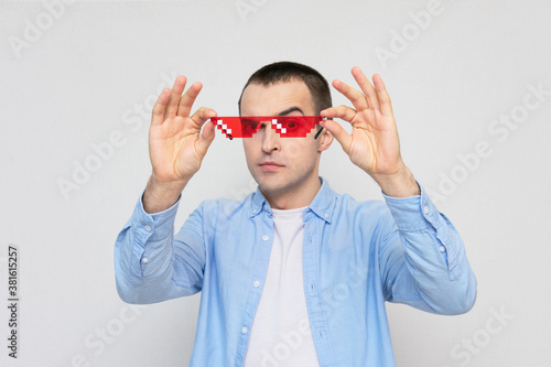 Young film fan with red pixel glasses  portrait  white background