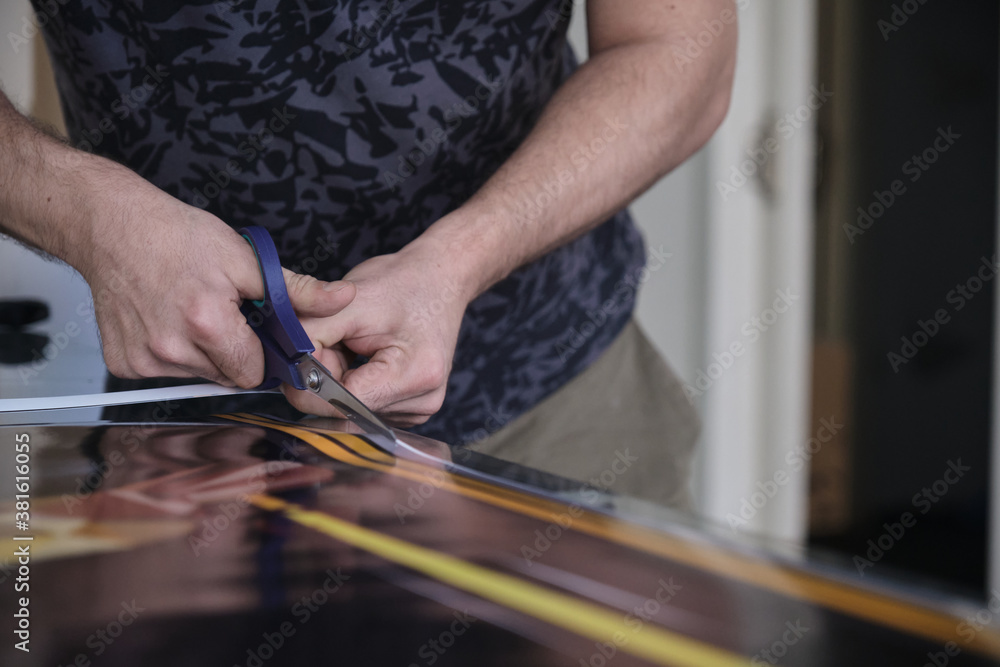 Man cutting print paper with scissors
Man cutting print paper with scissors