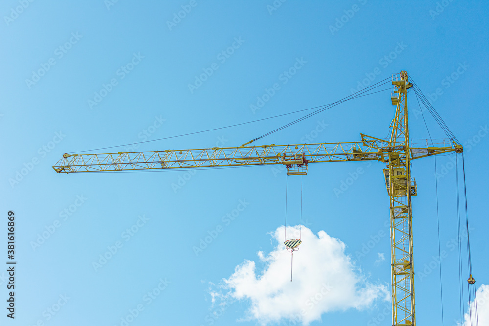 Construction crane on blue sky background with clouds Construction crane on blue sky background with clouds