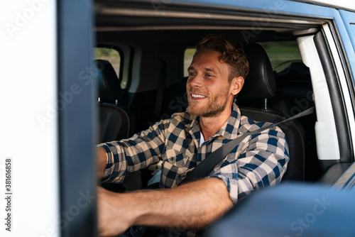 Handsome young man on a front seat of car