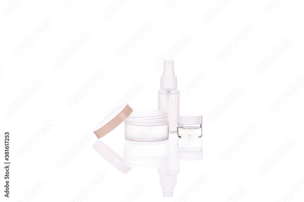 Set of transparent cosmetic bottle and jars with liquids isolated on white background. Beauty, natural cosmetics, daily personal care routine, skin care products, dermatology concept, copy space Set of transparent cosmetic bottle and jars with liquids isolated on white background. Beauty, natural cosmetics, daily personal care routine, skin care products, dermatology concept, copy space