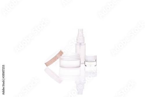 Set of transparent cosmetic bottle and jars with liquids isolated on white background. Beauty, natural cosmetics, daily personal care routine, skin care products, dermatology concept, copy space