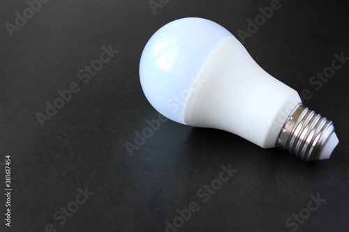 Light bulb on a black background with copy space. 