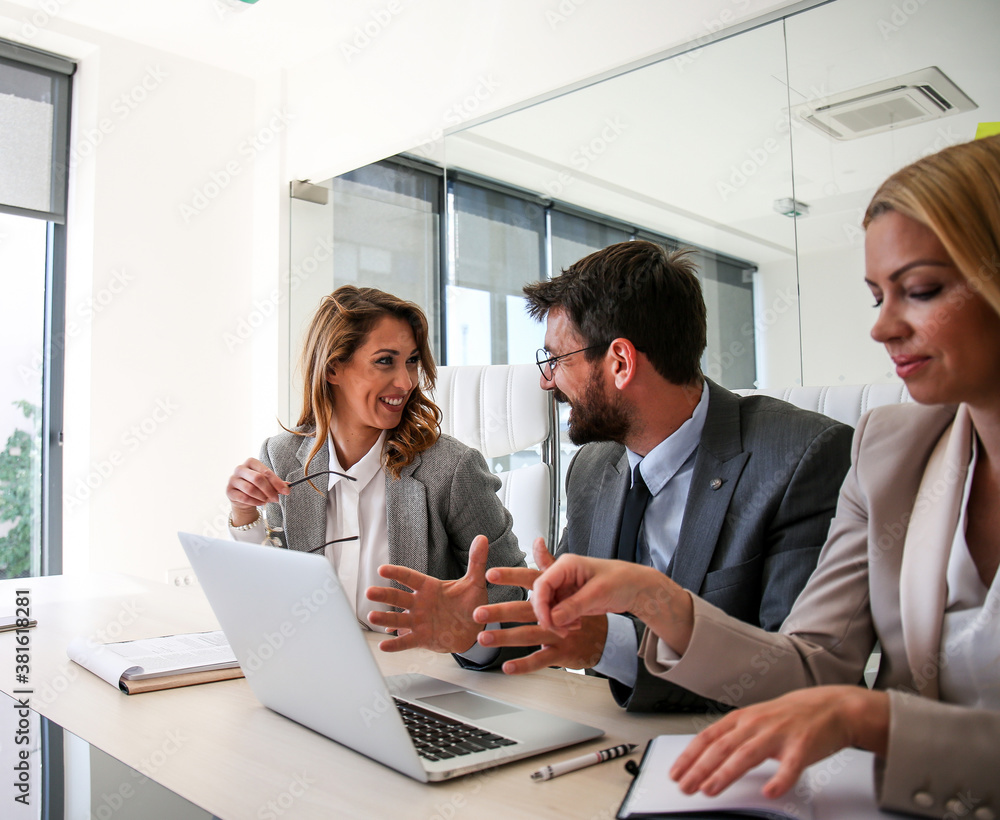 Colleagues sit at a desk in the office and analyze the work, discuss and looking for a solution Colleagues sit at a desk in the office and analyze the work, discuss and looking for a solution