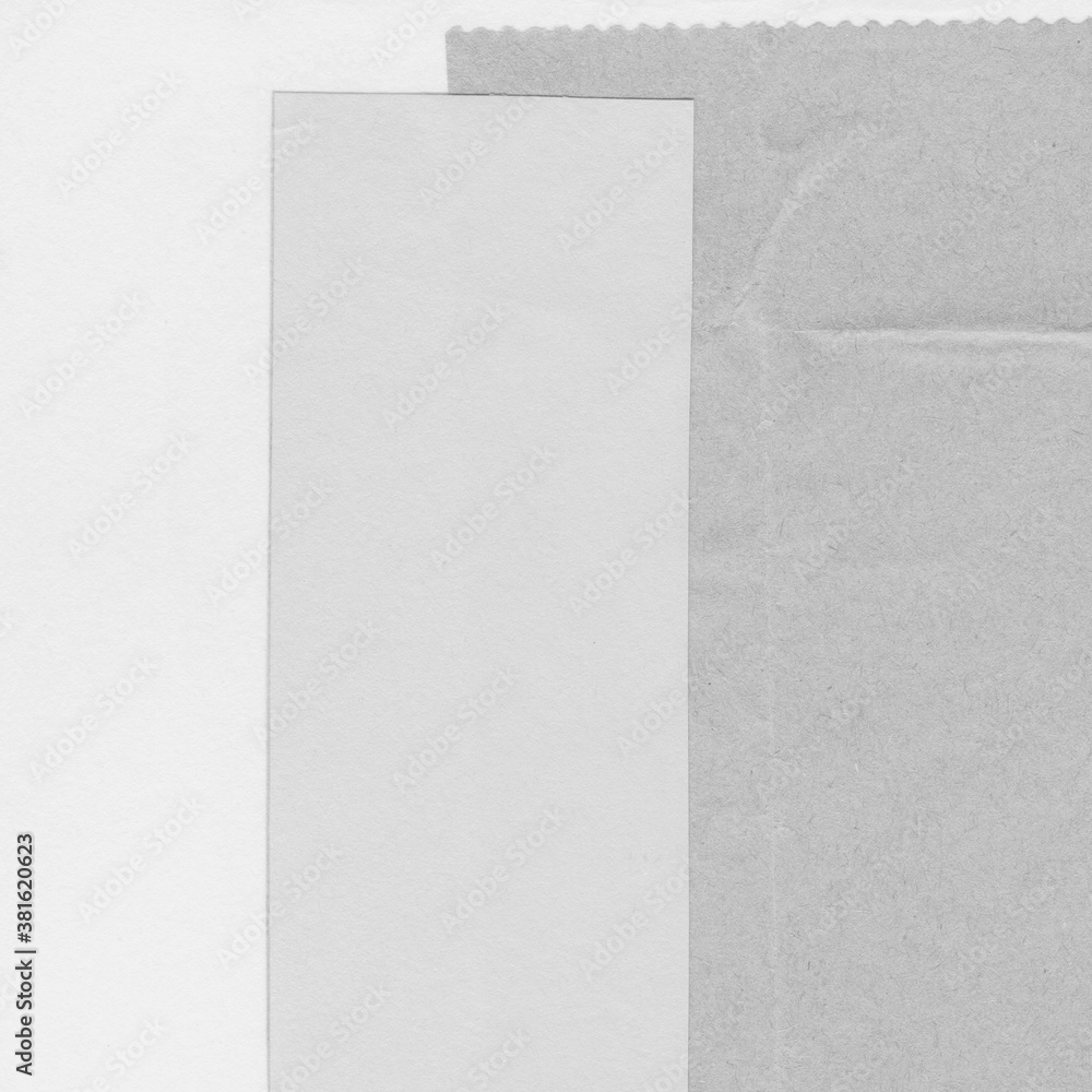 Fototapeta premium White torn paper collage close-up. Texture made from various paper and cardboard parts. Damaged old paper background. Vintage blank wallpaper. Material design backdrop.