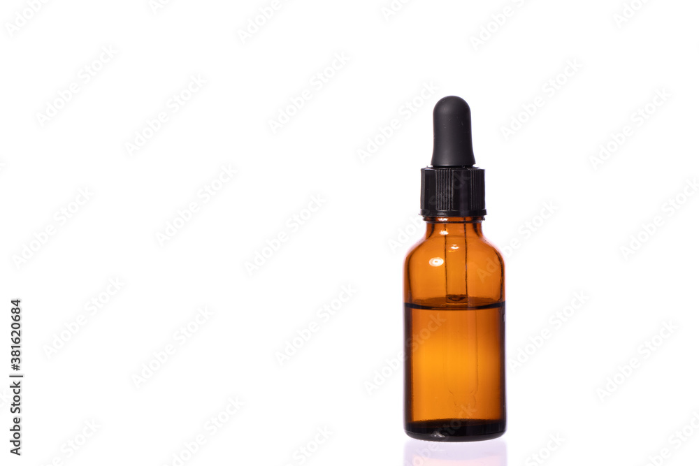 glass cosmetic brown bottle with pipette and clear transparent liquid. Eye or nasal drops isolated on white background copy space. rejuvenating agent advertising
