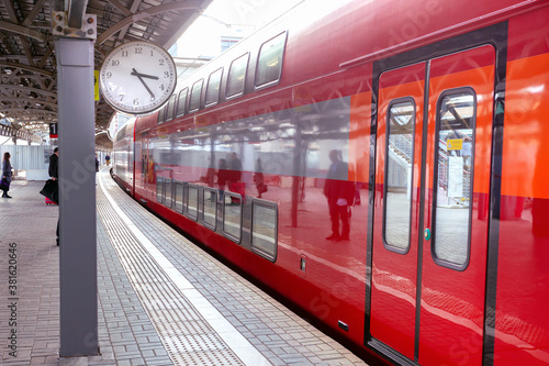 Modern train in the station with clock. Selective focus.
