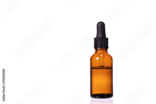glass cosmetic brown bottle with pipette and clear transparent liquid. Eye or nasal drops isolated on white background copy space. rejuvenating agent advertising