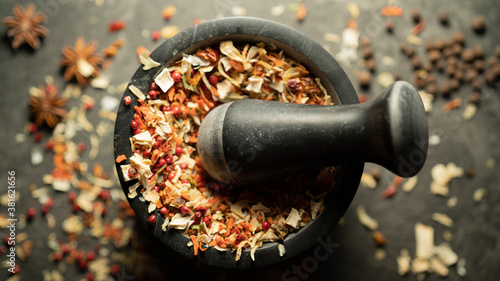 Fototapeta Naklejka Na Ścianę i Meble -  TOP VIEW: Grinding spices herbs in a mortar with pestle