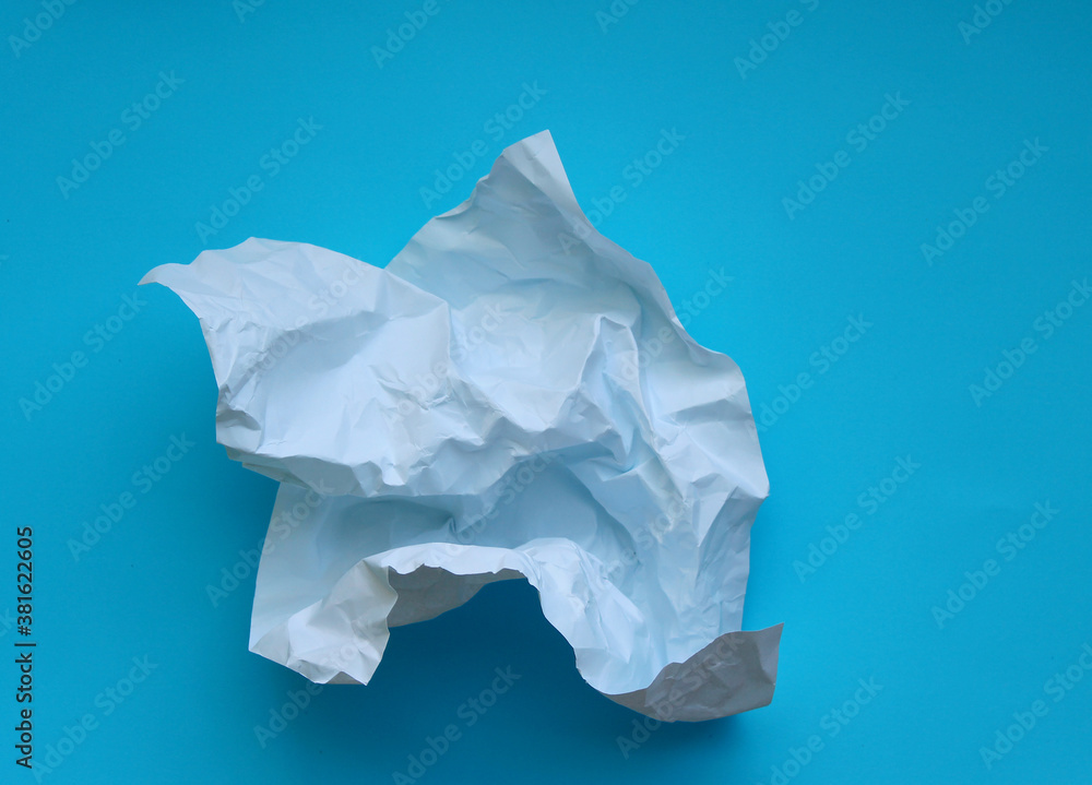 Crumpled paper isolated on blue background . Crumpled paper isolated on blue background .