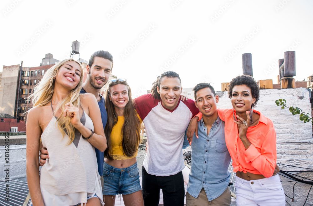 Group of friends spending time together on a rooftop in New york city, lifestyle concept with happy people Group of friends spending time together on a rooftop in New york city, lifestyle concept with happy people
