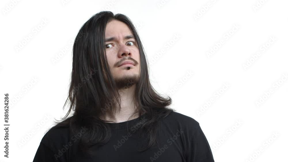 Close-up of east-asian guy with long hairstyle, piercing on face, looking surprised and shocked, reacting to something strange, standing in black t-shirt Close-up of east-asian guy with long hairstyle, piercing on face, looking surprised and shocked, reacting to something strange, standing in black t-shirt