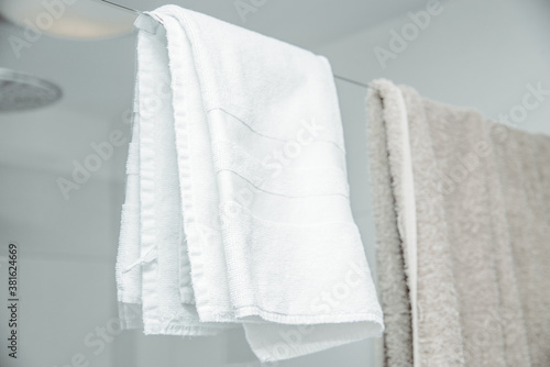Towels in the bathroom. Concept of drying hands and body with towels. Taking care of personal hygiene, using towels.