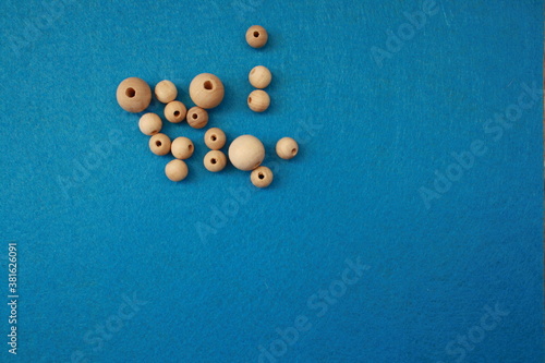 wooden beads on the blue felt background