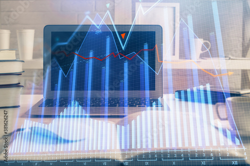 Financial graph colorful drawing and table with computer on background. Double exposure. Concept of international markets. © peshkova