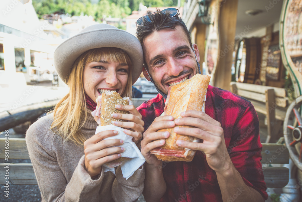 Happy couple eating a snack in a cafè. Happy couple eating a snack in a cafè.