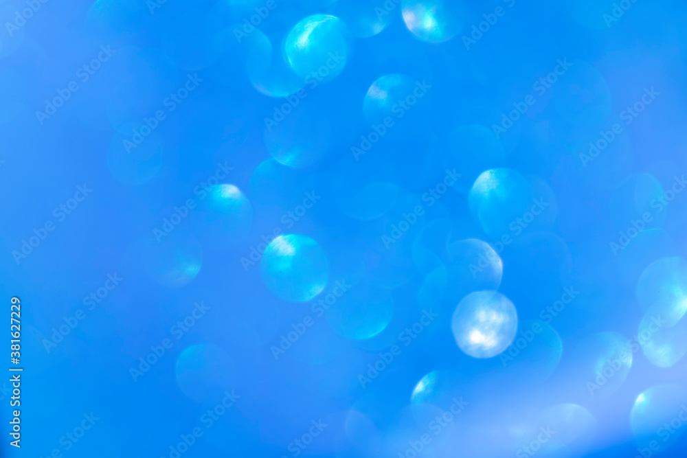 Blue abstract background bokeh blurred beautiful shiny lights Christmas. The background is shiny white. Divorces and blurry balls of light gray color. Blue abstract background bokeh blurred beautiful shiny lights Christmas. The background is shiny white. Divorces and blurry balls of light gray color.