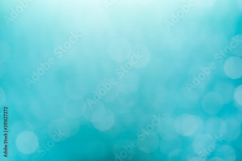 Bokeh light on blue background, sky with circle glitter light blur. Abstract soft glowing snow with vivid bright light and bokeh blur effect