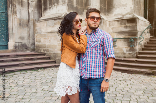 young couple in love traveling, vintage style, europe vacation, honey moon, sunglasses, old city center, happy positive mood, smiling, embracing