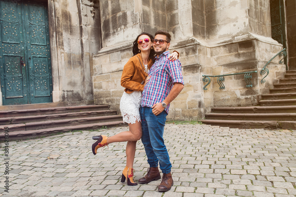 young couple in love traveling, vintage style, europe vacation, honey moon, sunglasses, old city center, happy positive mood, smiling, embracing