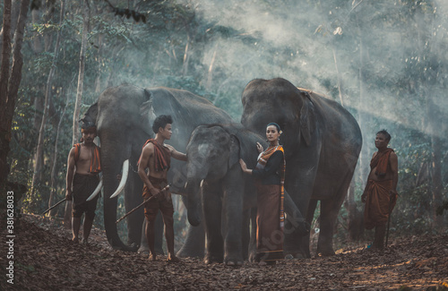 Group of thai shepherds in the jungle with elephants. Historic lifestyle moments from thailand culture