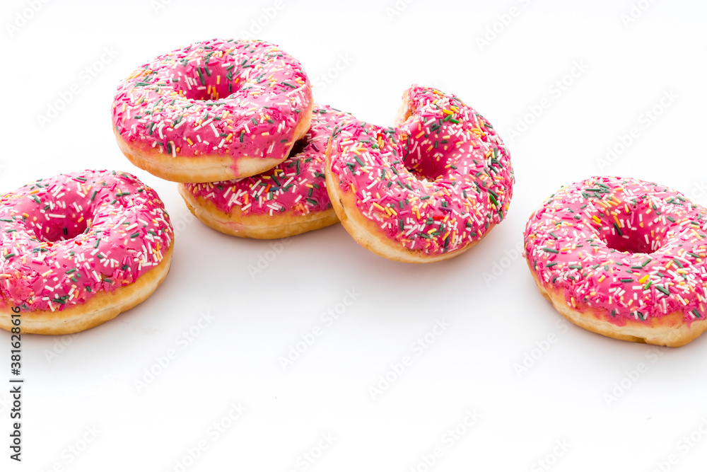 Pink berry donuts close up. Glazed and sprinkles bakery Pink berry donuts close up. Glazed and sprinkles bakery