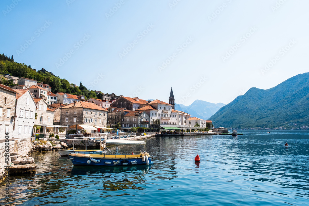 Harbour and boats in sunny day at Boka Kotor bay, Montenegro. Balkans, Adriatic sea, Europe.