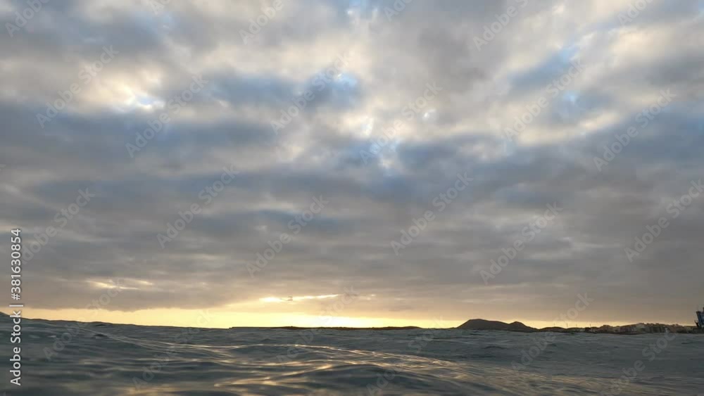 landscape and beautiful sunset view from the water of the sea or ocean - swimming and enjoying the evening at the beach in the ocean landscape and beautiful sunset view from the water of the sea or ocean - swimming and enjoying the evening at the beach in the ocean