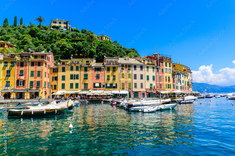 Portofino, Italy - Harbor town with colorful houses and yacht in little bay. Liguria, Genoa province, Italy. Italian fishing village with beautiful sea coast landscape in summer season.